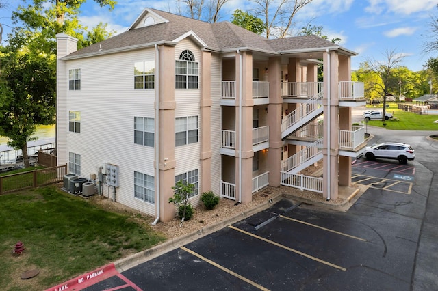 77 Anglers Pointe Unit 4, Branson, MO 65616 - view of building exterior featuring uncovered parking, fence, and central air condition unit