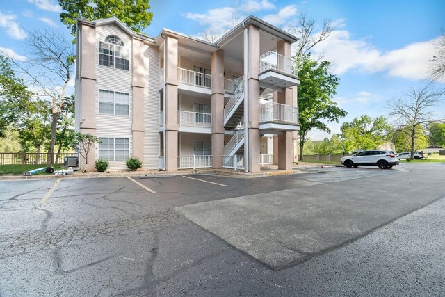 77 Anglers Pointe Unit 4, Branson, MO 65616 - view of building exterior featuring uncovered parking and fence