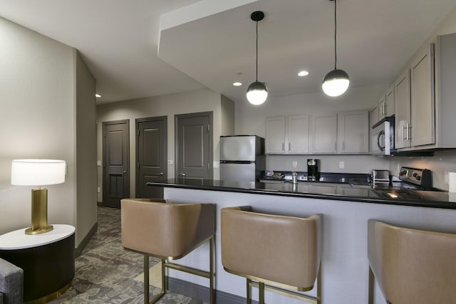 2312 Branson Landing Blvd Unit A, Branson, MO 65616 - kitchen with stainless steel appliances, dark countertops, gray cabinets, a peninsula, and recessed lighting