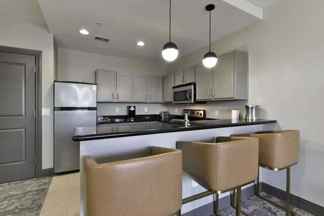 2312 Branson Landing Blvd Unit A, Branson, MO 65616 - kitchen featuring stainless steel appliances, gray cabinets, a peninsula, dark countertops, and recessed lighting