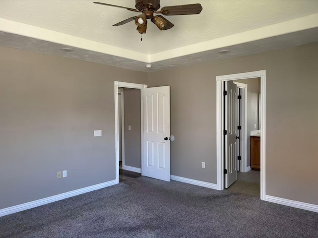 unfurnished bedroom with carpet floors, baseboards, and a ceiling fan