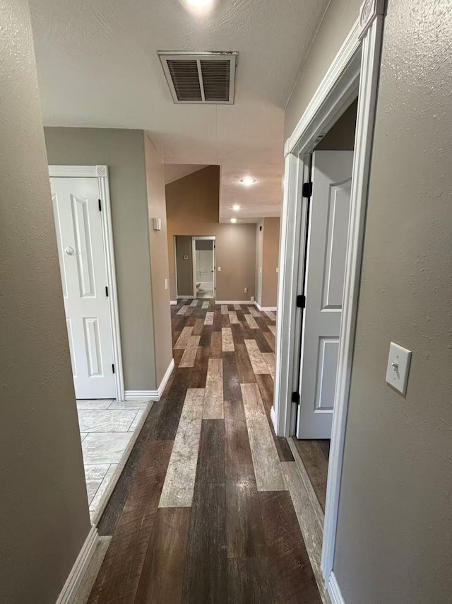 hall featuring hardwood / wood-style floors and baseboards