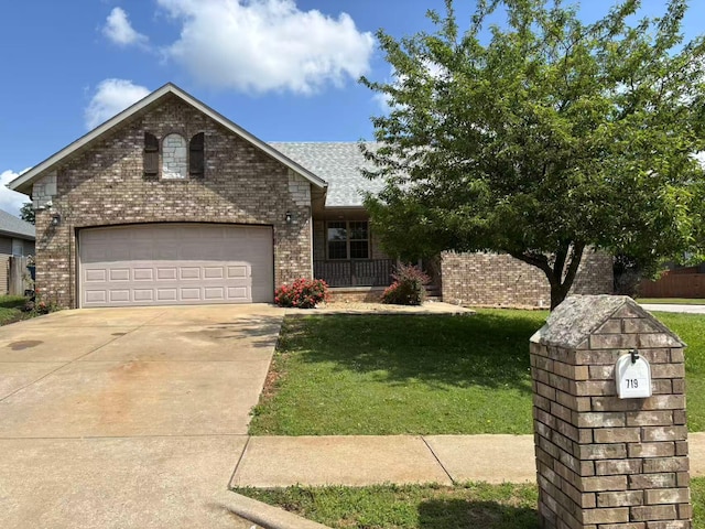 view of front of home featuring brick siding, driveway, and a front yard