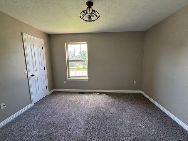 carpeted spare room with baseboards