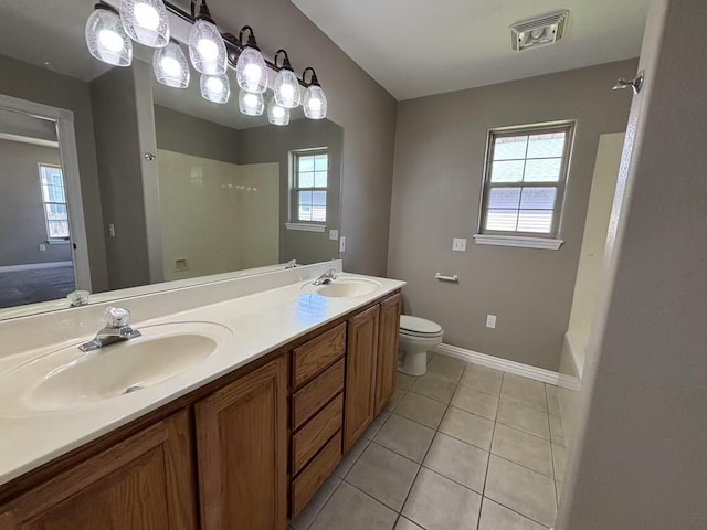 bathroom with healthy amount of natural light, baseboards, a shower, and toilet
