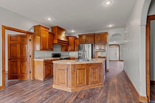 1602 E Fairwind, Ozark, MO 65721 - kitchen with black electric range oven, arched walkways, custom exhaust hood, stainless steel fridge with ice dispenser, and a sink