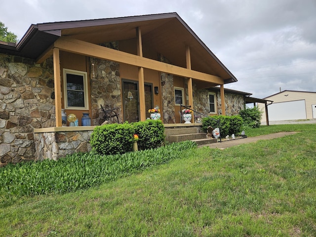 1100 County Road 8270, West Plains, MO 65775 - view of front of home with stone siding, covered porch, a front lawn, and a garage