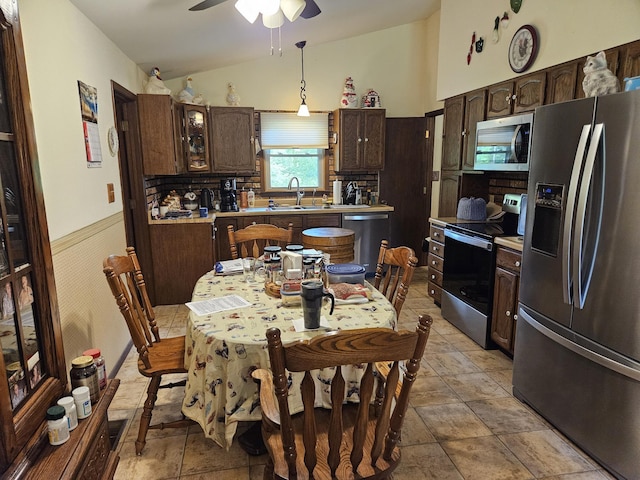 1100 County Road 8270, West Plains, MO 65775 - kitchen with appliances with stainless steel finishes, dark brown cabinetry, light countertops, a sink, and lofted ceiling
