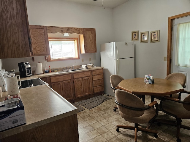 1100 County Road 8270, West Plains, MO 65775 - kitchen with freestanding refrigerator, a sink, and brown cabinets