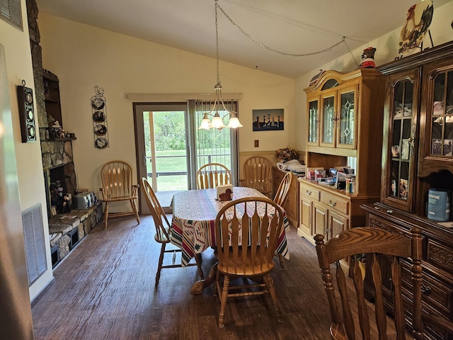 1100 County Road 8270, West Plains, MO 65775 - dining room with lofted ceiling, a fireplace, a chandelier, and dark wood-style floors