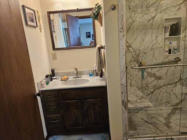 1100 County Road 8270, West Plains, MO 65775 - bathroom with a marble finish shower, vanity, and a textured wall