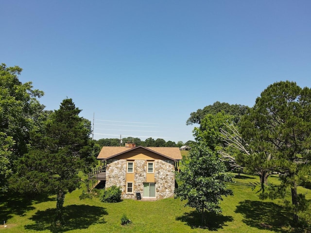 1100 County Road 8270, West Plains, MO 65775 - view of home's exterior with stone siding, a yard, a chimney, and a balcony