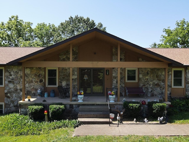 1100 County Road 8270, West Plains, MO 65775 - rear view of house with stone siding, covered porch, and roof with shingles