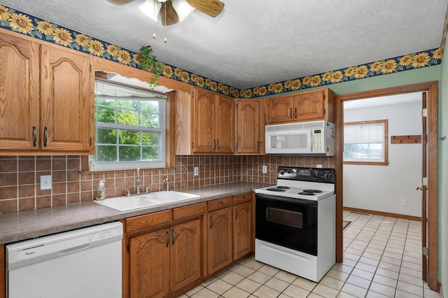 13860 Lawrence Unit 1158, Mount Vernon, MO 65712 - kitchen featuring white appliances, a sink, backsplash, plenty of natural light, and a textured ceiling