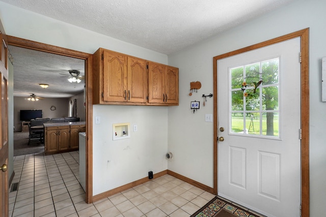 13860 Lawrence Unit 1158, Mount Vernon, MO 65712 - washroom featuring a textured ceiling, hookup for a washing machine, a ceiling fan, light tile patterned floors, and an office area