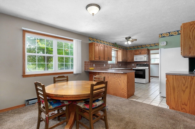 13860 Lawrence Unit 1158, Mount Vernon, MO 65712 - dining space featuring ceiling fan, light colored carpet, a textured ceiling, light tile patterned floors, and baseboards