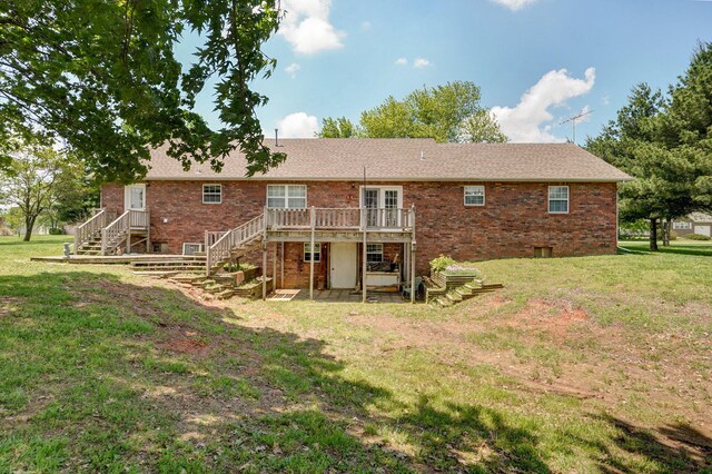13860 Lawrence Unit 1158, Mount Vernon, MO 65712 - rear view of house with stairs, a wooden deck, brick siding, and a yard