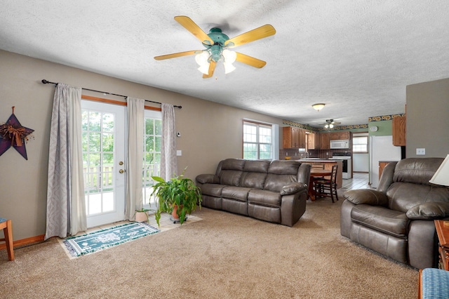 13860 Lawrence Unit 1158, Mount Vernon, MO 65712 - living area with a ceiling fan, a textured ceiling, and light carpet