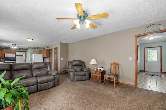 13860 Lawrence Unit 1158, Mount Vernon, MO 65712 - living area with a ceiling fan, light colored carpet, a textured ceiling, baseboards, and light tile patterned floors