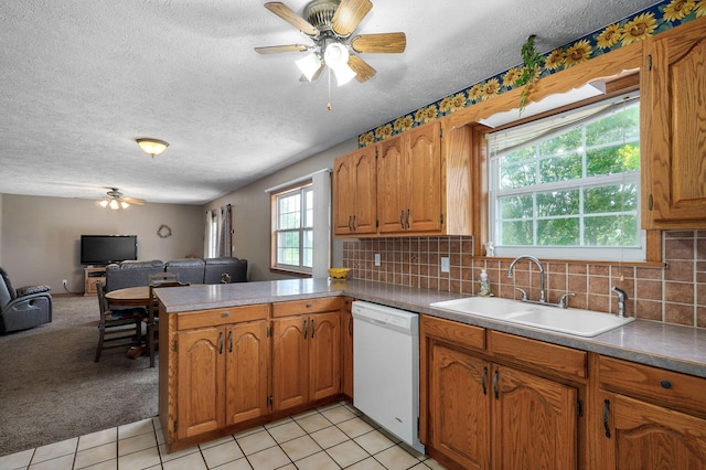 13860 Lawrence Unit 1158, Mount Vernon, MO 65712 - kitchen with white dishwasher, ceiling fan, a sink, open floor plan, and brown cabinets