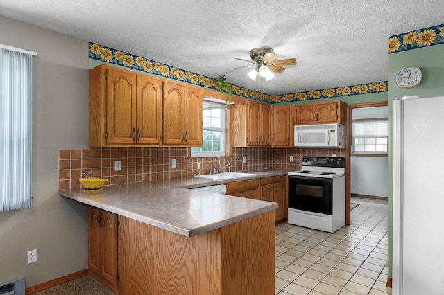 13860 Lawrence Unit 1158, Mount Vernon, MO 65712 - kitchen with white appliances, a sink, a peninsula, a ceiling fan, and backsplash