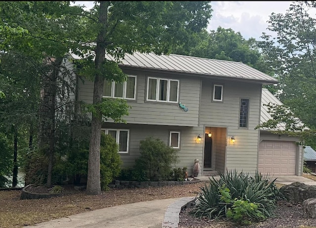136 Riverview Dr, Mammoth Spring, AR 72554 - view of front of home with metal roof, a standing seam roof, and a garage