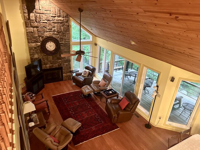 136 Riverview Dr, Mammoth Spring, AR 72554 - living area featuring wooden ceiling, wood finished floors, plenty of natural light, a stone fireplace, and ceiling fan