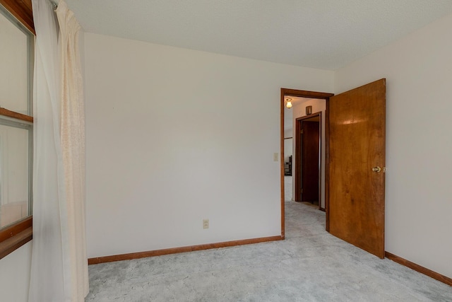 carpeted spare room with baseboards