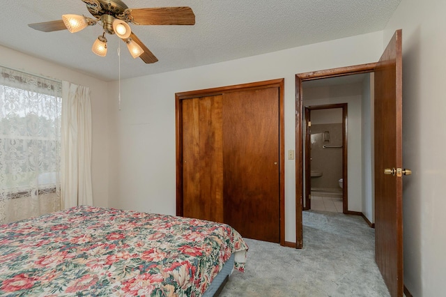 bedroom with carpet, a closet, ceiling fan, baseboards, and a textured ceiling