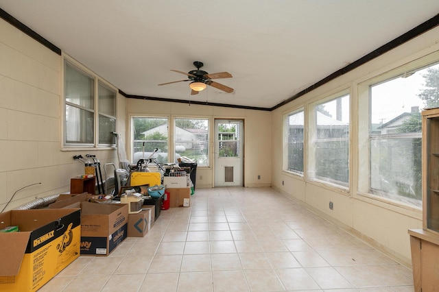 sunroom / solarium featuring crown molding and tile patterned flooring