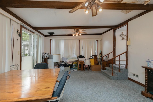 carpeted dining room featuring a ceiling fan, beam ceiling, stairway, and baseboards