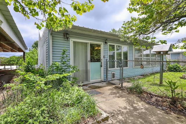 view of exterior entry with fence