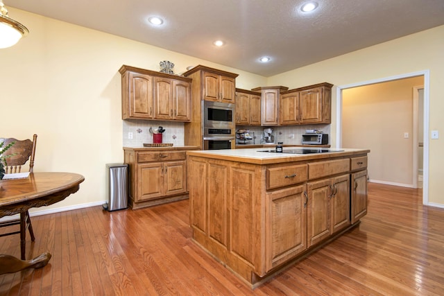 904 W Crater Cir, Nixa, MO 65714 - kitchen with appliances with stainless steel finishes, baseboards, dark wood-type flooring, light countertops, and recessed lighting