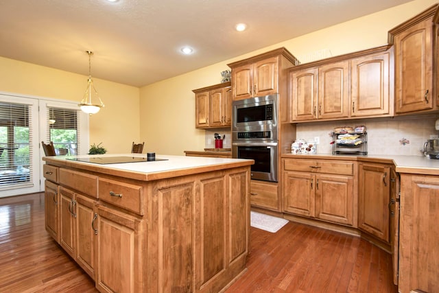 904 W Crater Cir, Nixa, MO 65714 - kitchen with stainless steel appliances, dark wood-style floors, a kitchen island, tasteful backsplash, and recessed lighting