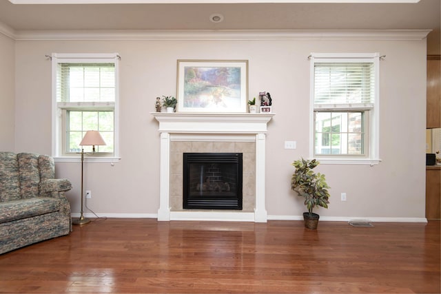 904 W Crater Cir, Nixa, MO 65714 - living area featuring wood finished floors, baseboards, a tiled fireplace, and crown molding