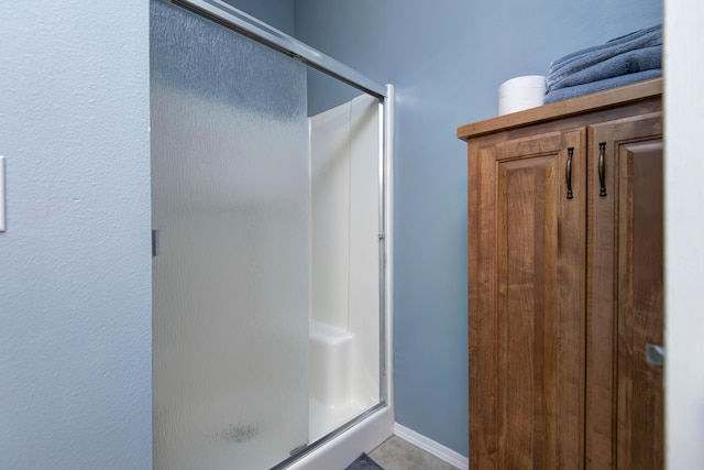 904 W Crater Cir, Nixa, MO 65714 - bathroom featuring a shower stall and baseboards