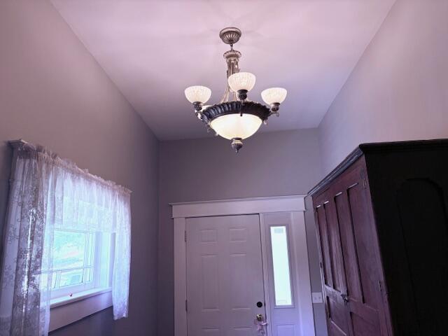 foyer with a chandelier