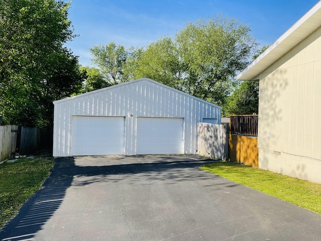 detached garage featuring fence