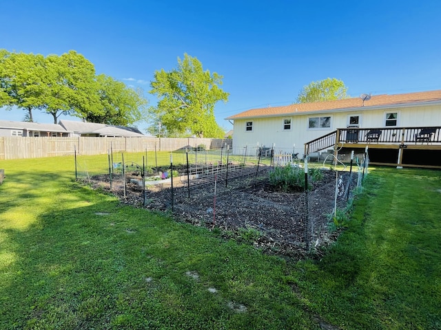 view of yard with a vegetable garden and a deck