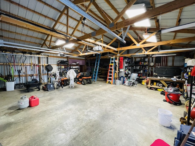 garage with a workshop area and a garage door opener