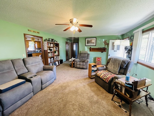 carpeted living area featuring a textured ceiling, a ceiling fan, and a sink