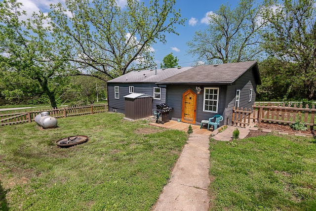 10870 N Farm Rd Unit 137, Brighton, MO 65617 - back of house with an outdoor fire pit, an outbuilding, a shed, and roof with shingles