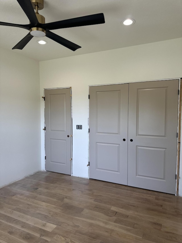 unfurnished bedroom featuring wood finished floors, recessed lighting, and a ceiling fan