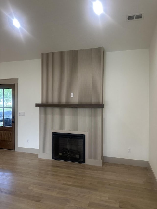 1988 Morris Rd, Mountain Grove, MO 65711 - unfurnished living room with wood finished floors and a fireplace