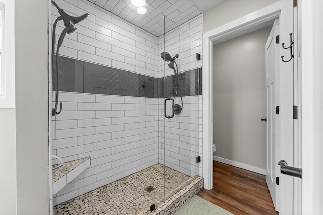 5376 S 140th Rd, Morrisville, MO 65710 - bathroom featuring a shower stall, toilet, wood finished floors, and baseboards