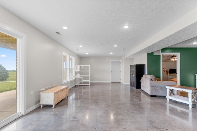 5376 S 140th Rd, Morrisville, MO 65710 - living room featuring concrete floors, a textured ceiling, baseboards, and recessed lighting