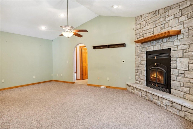 580 Cedar Hill Ln, Marshfield, MO 65706 - unfurnished living room with carpet floors, baseboards, a stone fireplace, vaulted ceiling, and arched walkways
