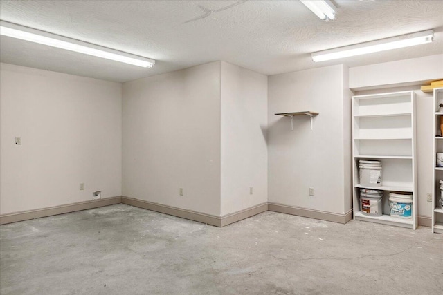 580 Cedar Hill Ln, Marshfield, MO 65706 - below grade area featuring a textured ceiling and baseboards