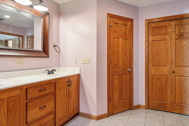 580 Cedar Hill Ln, Marshfield, MO 65706 - bathroom featuring baseboards, double vanity, and tile patterned flooring