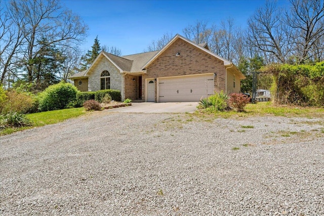 580 Cedar Hill Ln, Marshfield, MO 65706 - ranch-style house with driveway, an attached garage, brick siding, and stone siding